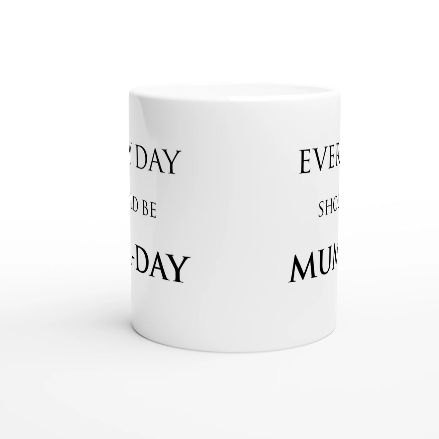 A white ceramic mug with the pun, "Every day should be Mum-day" on both sides