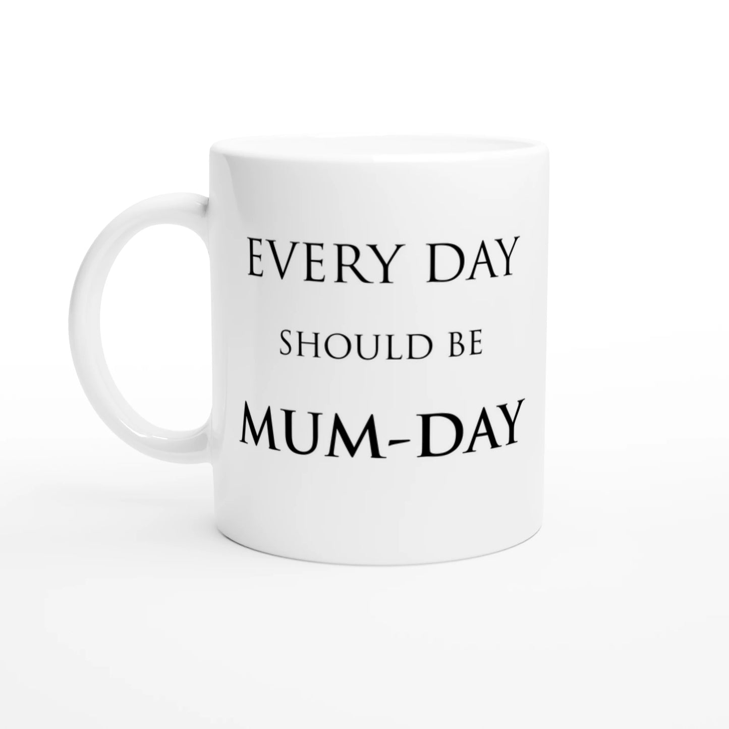 A white ceramic mug with the pun, "Every day should be Mum-day"