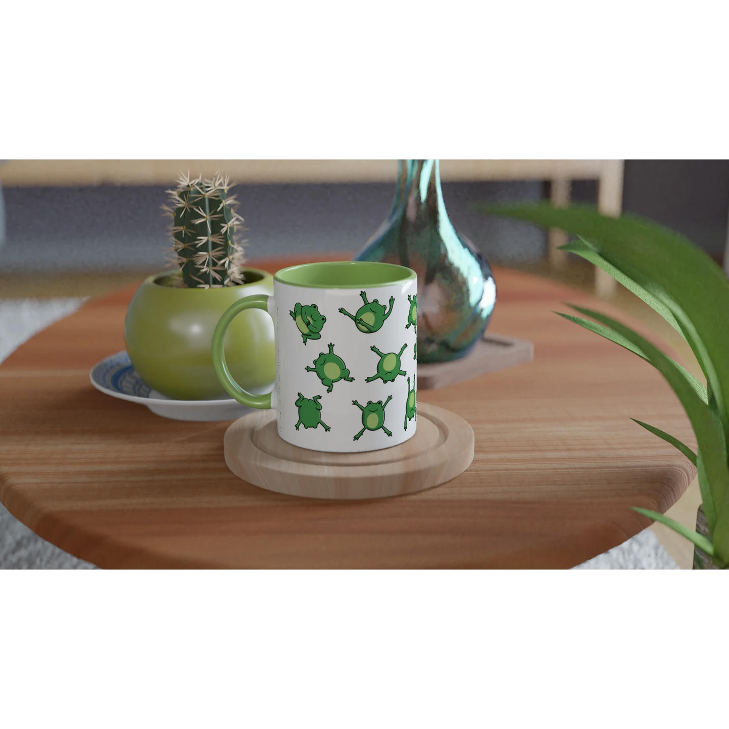 Astral Apple dish washer safe, microwave safe ceramic coffee mug in White and Green, with graphic print of lots of cute, smiling, cartoon style frogs , on a table, for the person who loves frogs