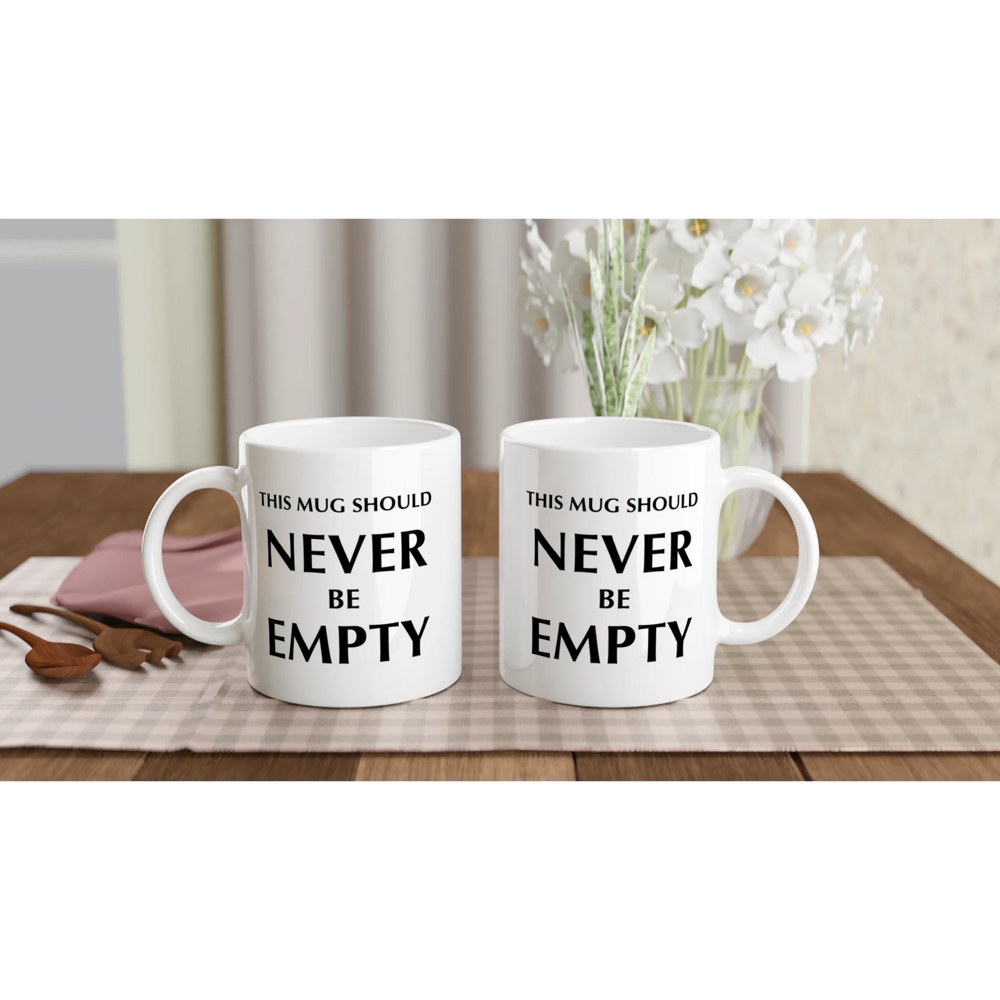 Astral Apple white, microwave and dishwasher safe, 11oz, ceramic mug with graphic print of the text, “This Mug Should Never Be Empty”, back and front view, funny mug design