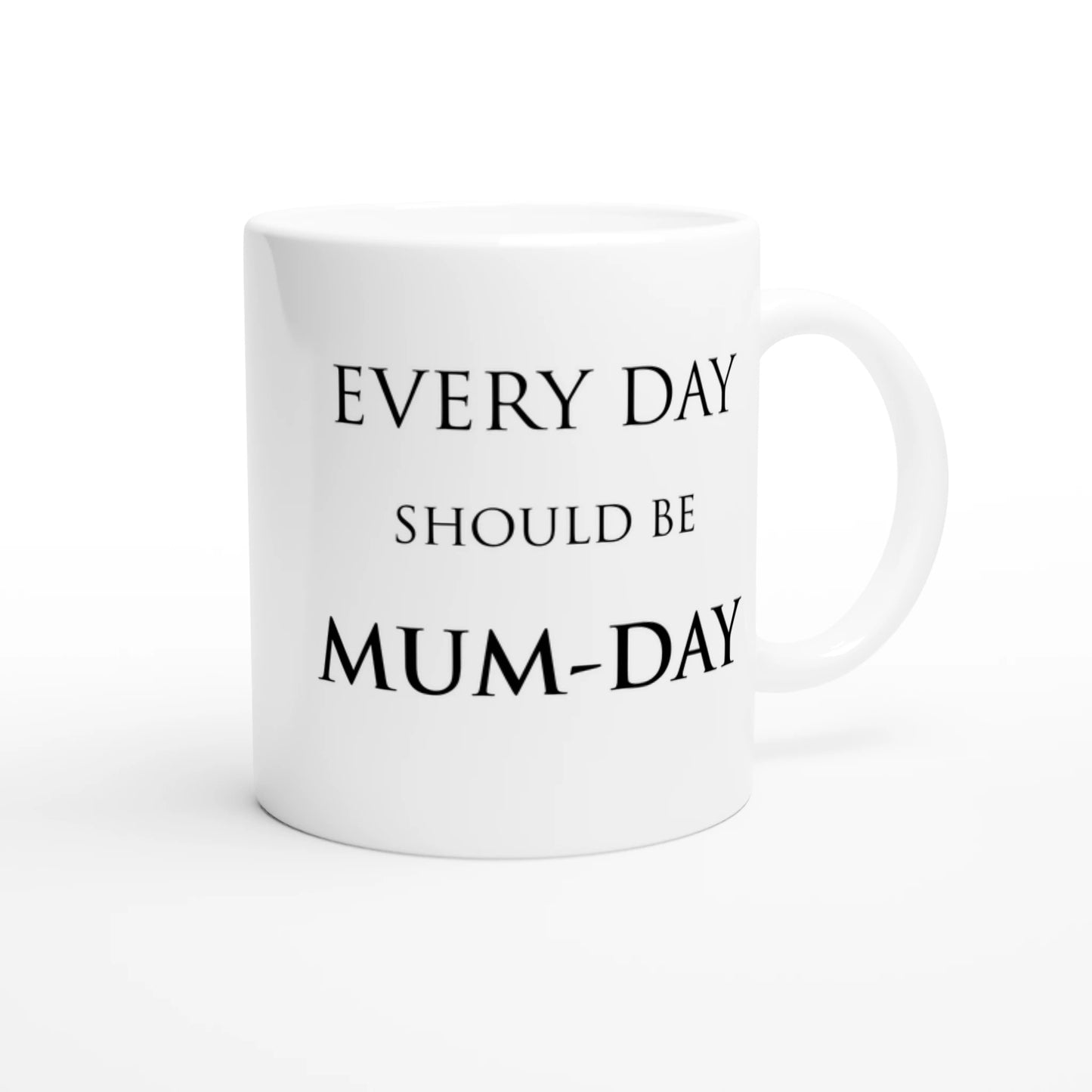 The front side of a white ceramic mug with the pun, "Every day should be Mum-day"