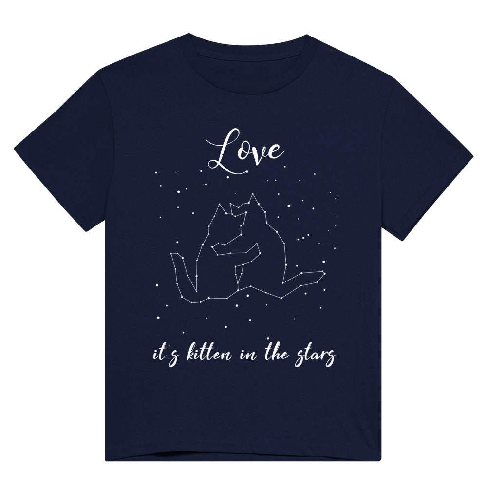 A navy blue t shirt with the words, "Love, it's kitten in the stars" in white and a picture of stars in the night sky, showing a cuddling cat pair constellation