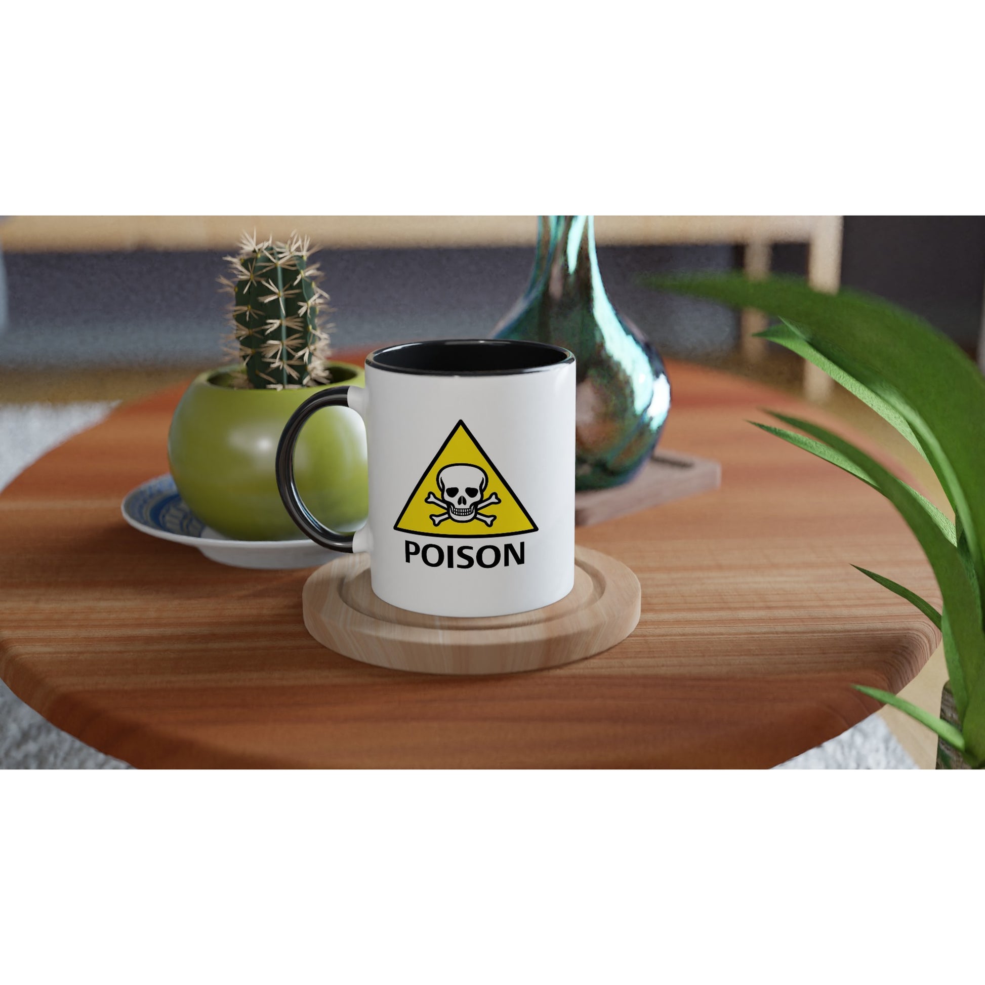 a white ceramic mug with black handle and interior with the poison hazard symbol on it and the text "poison", placed on a table.