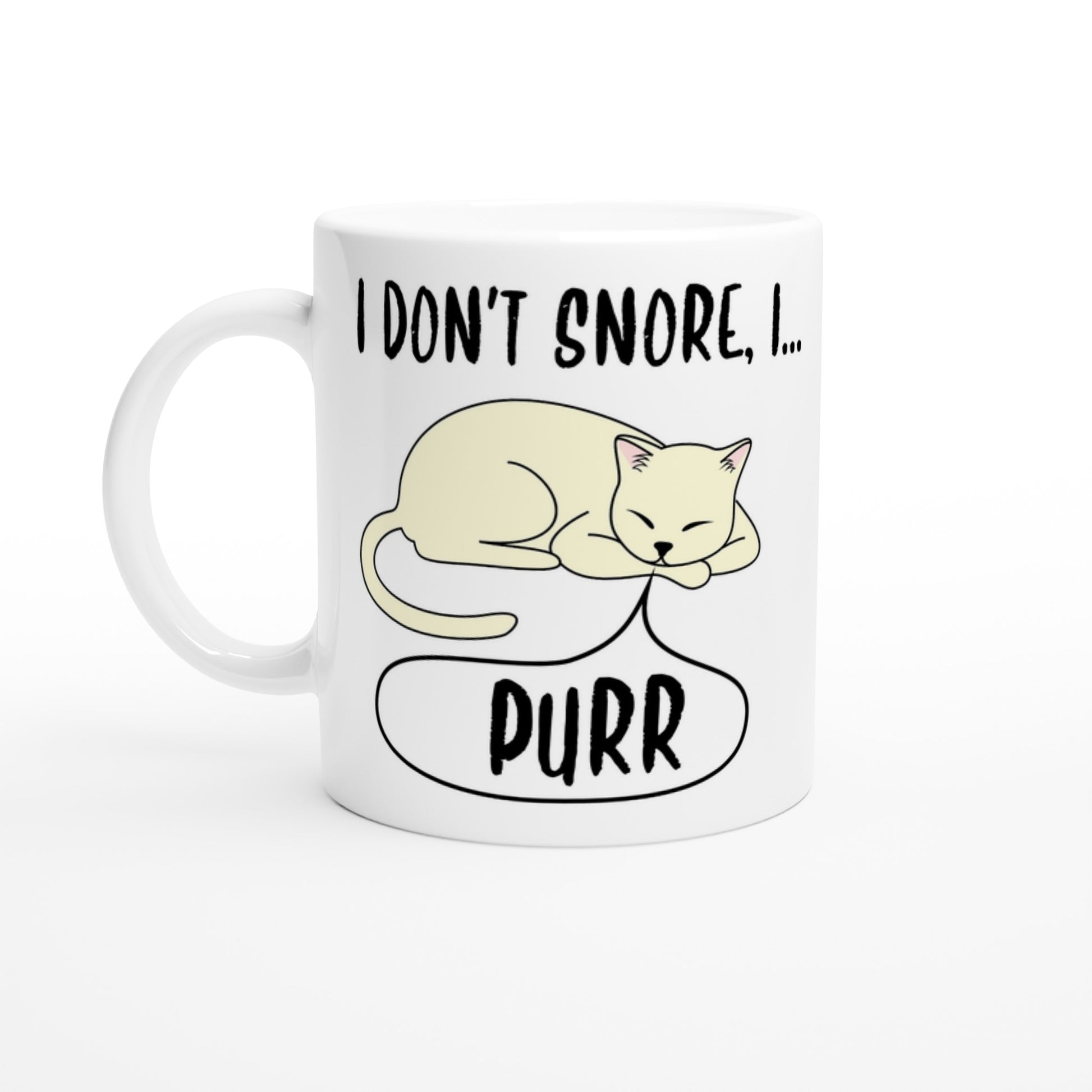 A white ceramic mug with the words, "I don't snore, I purr" in black and a pictre of a sleeping cat on it.