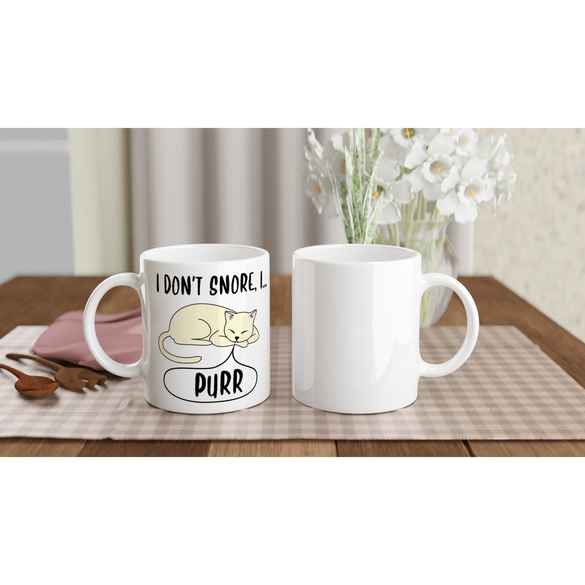 Front and back views of a white ceramic mug with the words, "I don't snore, I purr" in black and a pictre of a sleeping cat on it.