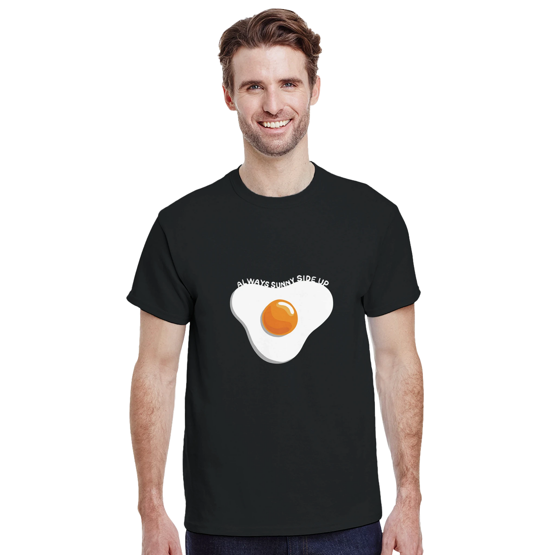 Astral Apple Men’s, Women’s or Unisex short sleeved, casual style classic crewneck t-shirt in Black cotton, with graphic print of a delicious fried egg and the text, "always sunny side up", on a model, happy, positive and yummy egg t-shirt