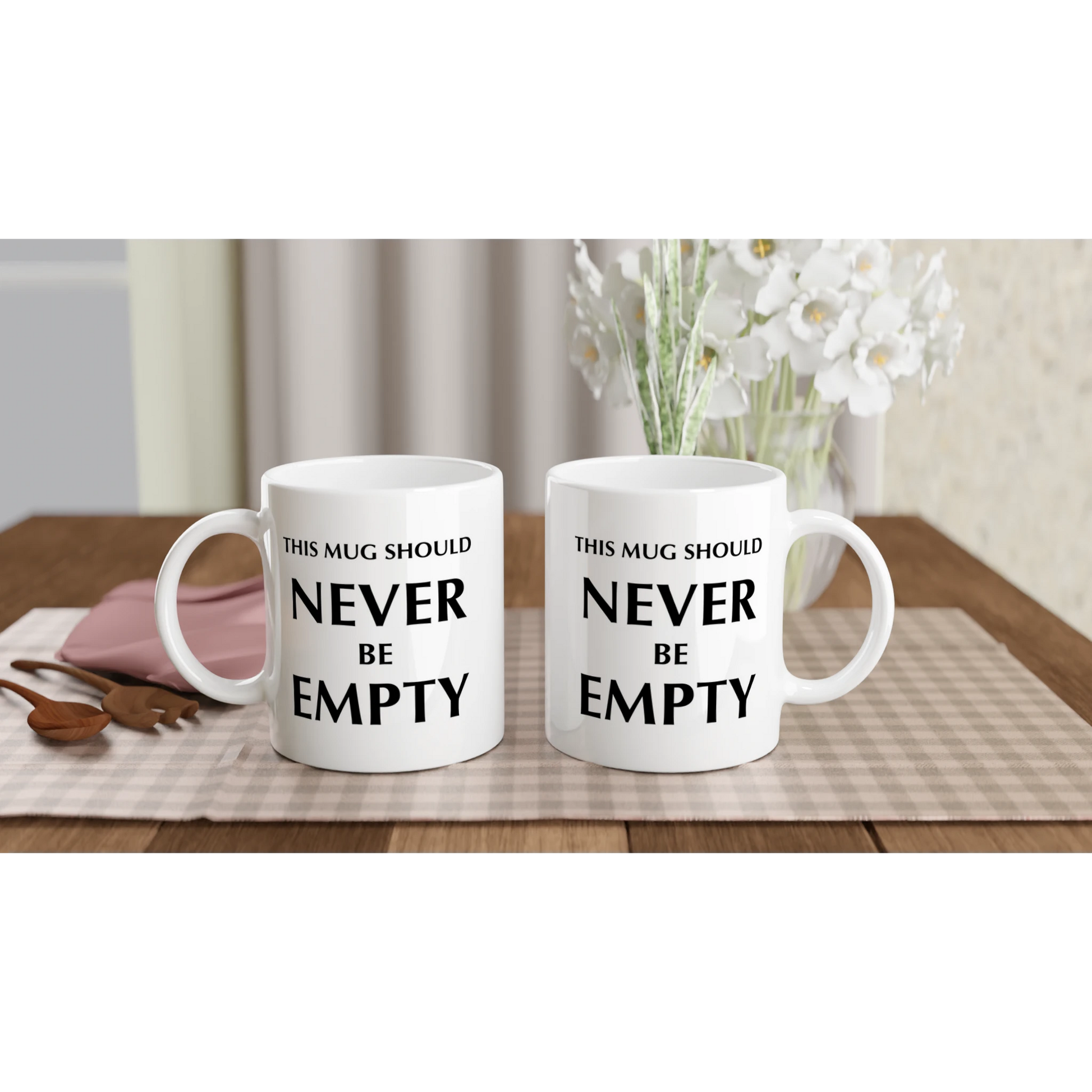 Astral Apple white, microwave and dishwasher safe, 11oz, ceramic mug with graphic print of the text, “This Mug Should Never Be Empty”, back and front view, funny mug design