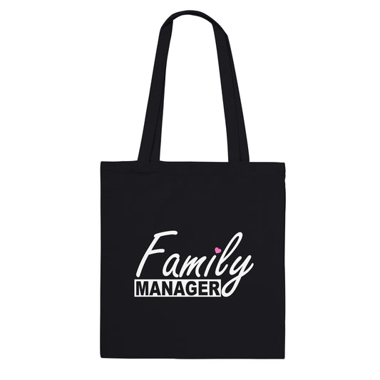 Black tote bag with the words "family manager" in white, where the letter "i" in family is dotted with a small pink heart.