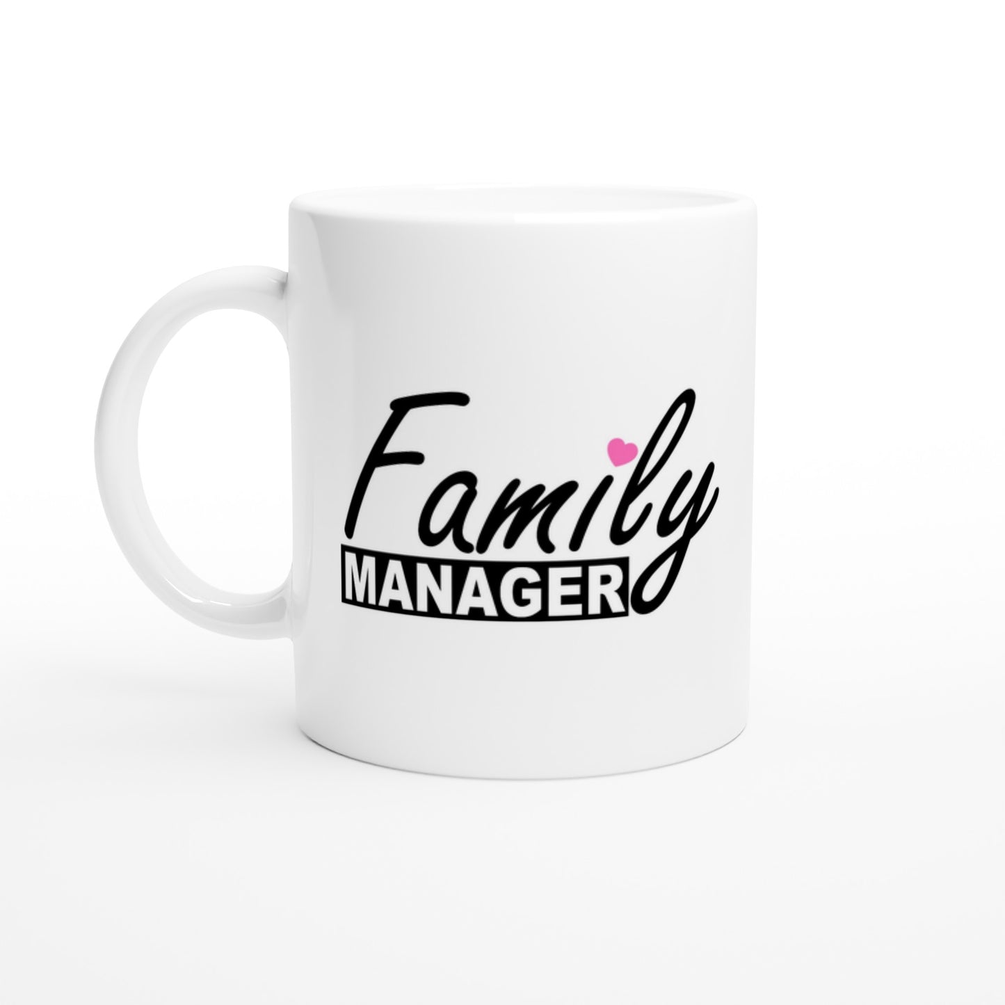 White ceramic mug with the words "family manager" in black, where the letter "i" in family is dotted with a small pink heart.