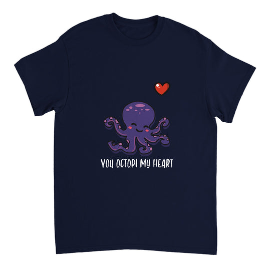 A navy blue t shirt with white text saying, "You octopi my heart" and an image of a purple octopus blushing and smiling and a small red heart in the upper right corner