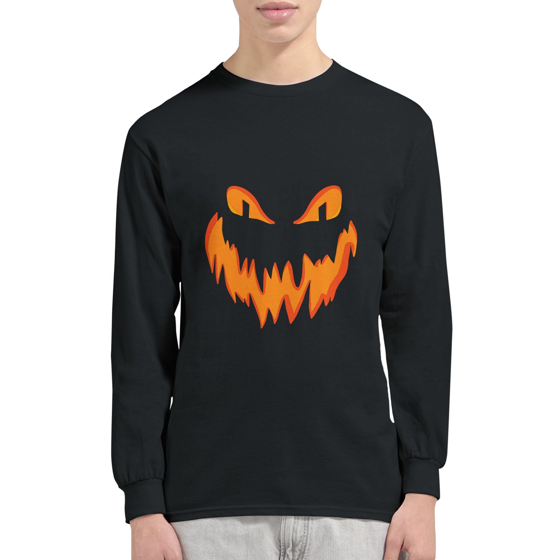 A black, long sleeved Halloween t shirt with a spooky smiling Jack o' Lantern pumpkin face worn by a man.