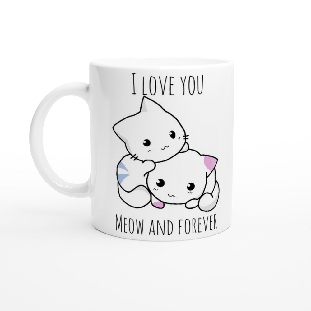 A white ceramic mug with the pun, "I love you meow and forever" and a picture of a blue and white striped cat next to a white and pink spotted cat.