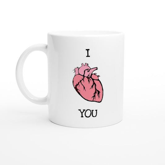 A white ceramic mug with the words "I 'heart' you" in black, where the heart is an anatomically correct illustration of a heart