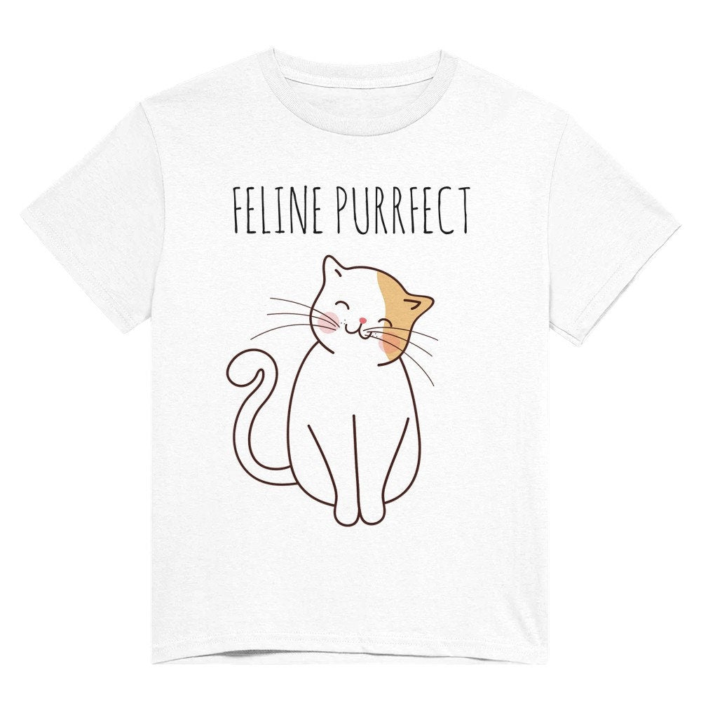 A white t shirt with the words "Feline purrfect" in black and a picture of a white and light brown cat smiling and sitting happily.