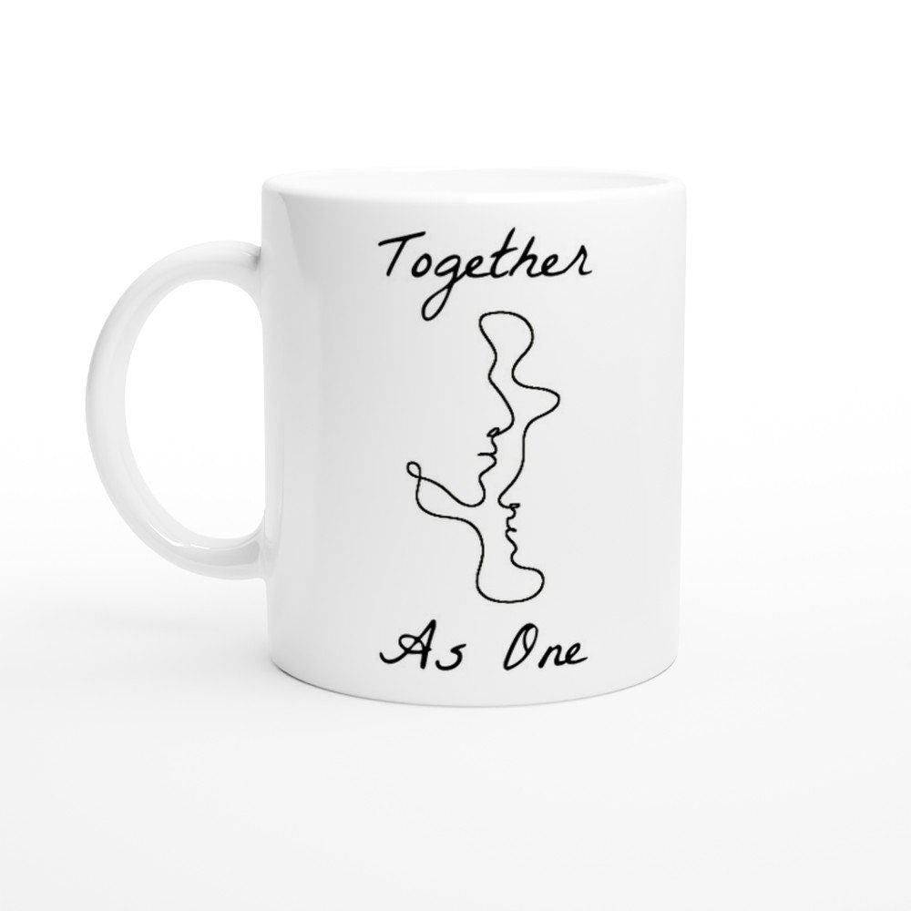 A white ceramic with the words, "together as one" written in black and an image of line art depicting two faces facing each other in one continuous line